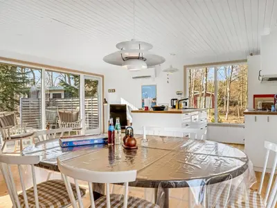 a kitchen and dining room with a table and chairs at Holiday Home Elisabete - 200m to the fjord by Interhome in Fur
