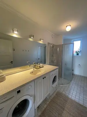 a bathroom with a sink and a washing machine at Modern Scandinavian Apartment in Viborg Centre in Viborg