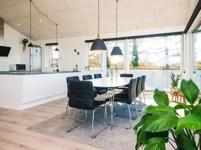 a kitchen and dining room with a table and chairs at 5 star holiday home in Løgstrup in Løgstrup