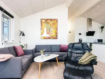 a living room with a couch and a table at 5 star holiday home in Løgstrup in Løgstrup