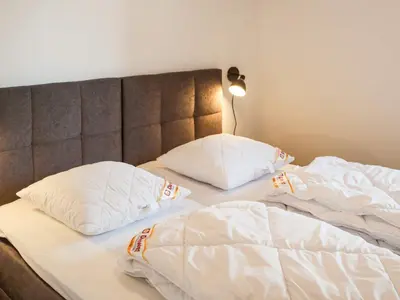 an unmade bed with two pillows on it at 5 star holiday home in Blokhus in Blokhus