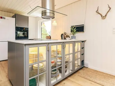 a kitchen with a counter with plates on it at 6 person holiday home in Pandrup in Pandrup