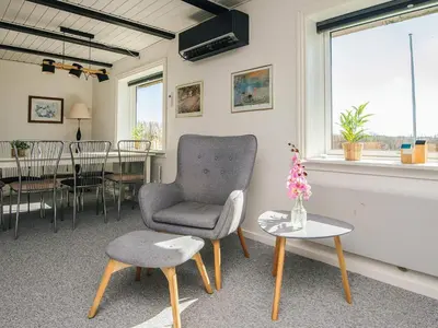 a living room with a chair and a table at 5 person holiday home in Snedsted in Snedsted