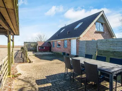 a house with a table and chairs in front of it at 5 person holiday home in Snedsted in Snedsted