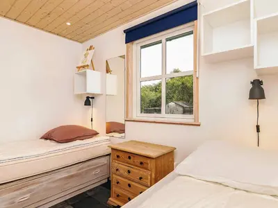 a bedroom with two beds and a window at 4 star holiday home in Spøttrup in Lihme