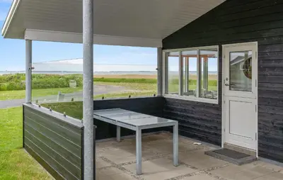 a porch with a bench next to a door at 2 Bedroom Stunning Home In Vinderup in Vinderup