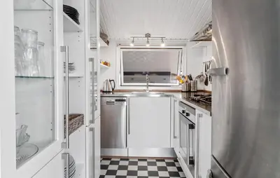 a white kitchen with a sink and a window at 2 Bedroom Stunning Home In Vinderup in Vinderup