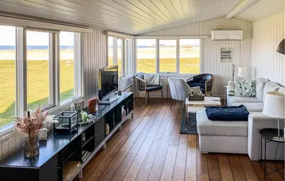a living room with a couch and a tv at 2 Bedroom Stunning Home In Vinderup in Vinderup
