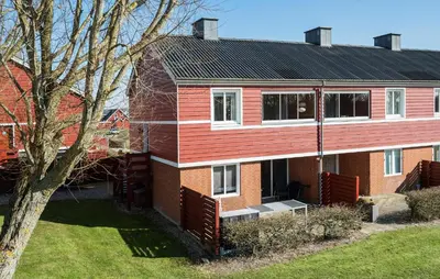 a red brick house with a black roof at Cozy Apartment In Lemvig With Sauna in Lemvig