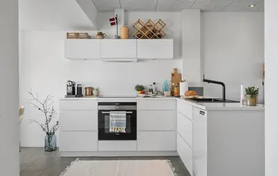 a kitchen with white cabinets and an oven at Cozy Apartment In Lemvig With Sauna in Lemvig