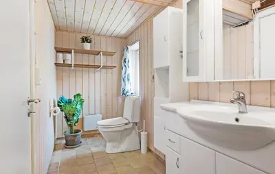 a bathroom with a toilet and a sink at Nice Home In Farsø With Wifi in Farsø