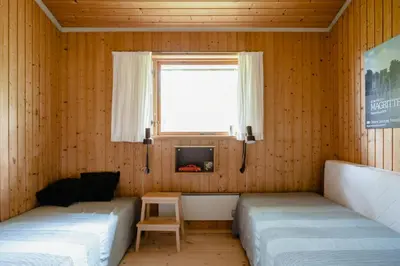 a living room with two beds and a window at Warm 70S Vibe Near Limfjord in Løgstør