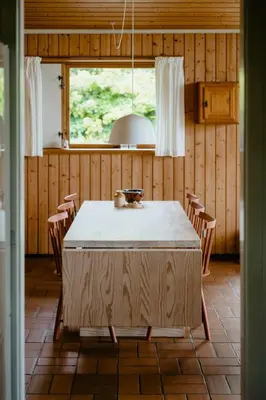 a kitchen with a table and chairs in a room at Warm 70S Vibe Near Limfjord in Løgstør
