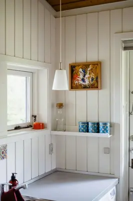 a kitchen with white walls and a window and a shelf at Warm 70S Vibe Near Limfjord in Løgstør