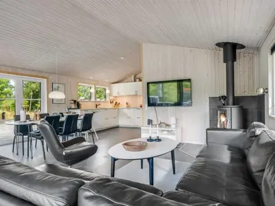 a living room with a couch and a table at Holiday Home Onni - 2-3km from the sea by Interhome in Saltum