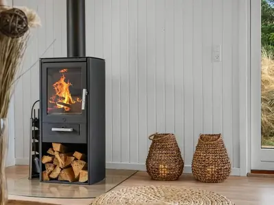a stove with a fire in a room at Holiday Home Gundborg - 200m from the sea by Interhome in Saltum