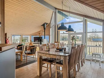 a kitchen and dining room with a table and chairs at Holiday Home Anline - 600m to the fjord by Interhome in Farsø