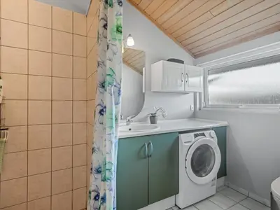 a bathroom with a washing machine and a sink at Holiday Home Anline - 600m to the fjord by Interhome in Farsø