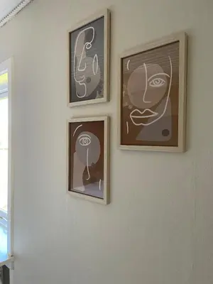 three framed pictures on a white wall at Stor lys lejlighed på 100 kvm, central beliggenhed in Holstebro