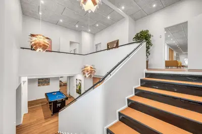 a hallway with stairs in a building with a pool table at Exclusive Pool Houseconference Center With Gymnasium in Erslev