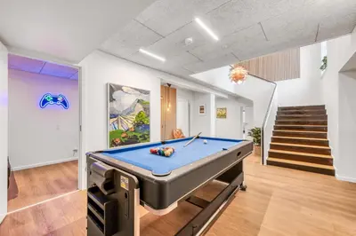 a pool table in a room with a staircase at Exclusive Pool Houseconference Center With Gymnasium in Erslev