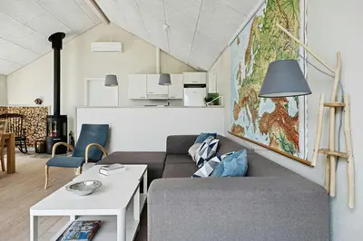 a living room with a couch and a table at Forest House With Stream By Hjarbæk Fjord in Højslev