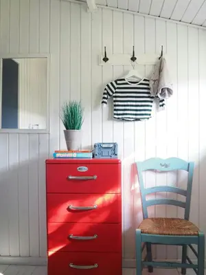 a red dresser and a chair in a room at Traditional Holiday Home At Cold Hawaii in Torsted