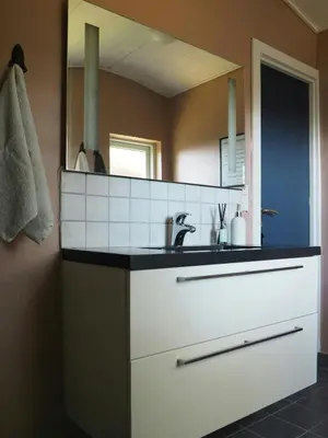 a bathroom with a sink and a mirror at Traditional Holiday Home At Cold Hawaii in Torsted