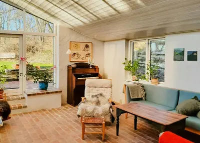 a living room with a couch and a table at Artist's House With Soul Near Hanklit in Flade