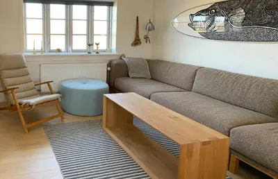 a living room with a couch and a coffee table at North Sea Atmosphere On The Farm In Klitmøller in Torsted