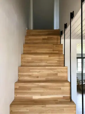 a staircase in a house with wooden treads at North Sea Atmosphere On The Farm In Klitmøller in Torsted