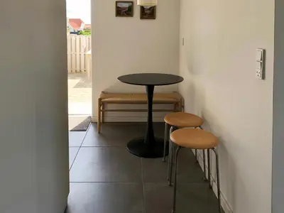 a small table and two stools in a room at North Sea Atmosphere On The Farm In Klitmøller in Torsted