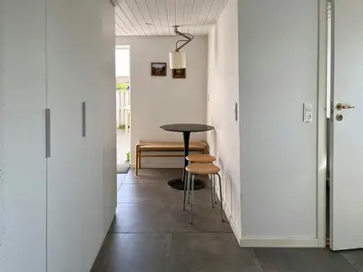 a hallway with a table and chairs in a room at North Sea Atmosphere On The Farm In Klitmøller in Torsted