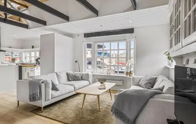 a living room with a couch and a table at Nice Home In Blokhus With Wifi in Blokhus