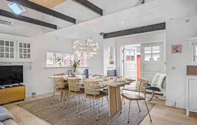 a dining room with a table and chairs at Nice Home In Blokhus With Wifi in Blokhus