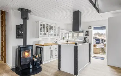 a kitchen with a stove in the middle of a room at Nice Home In Blokhus With Wifi in Blokhus