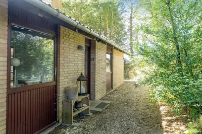 a side view of a brick house with a door at Cozy Holiday Home Near Lild Strand in Frøstrup