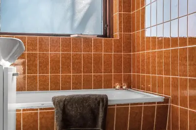 a bathroom with a tub and a window at Cozy Holiday Home Near Lild Strand in Frøstrup