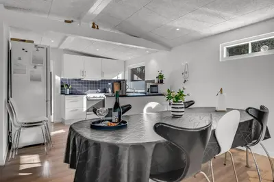 a kitchen with a table with a black table cloth on it at Holiday Home With Pool And Spa Close To The Limfjord in Roslev