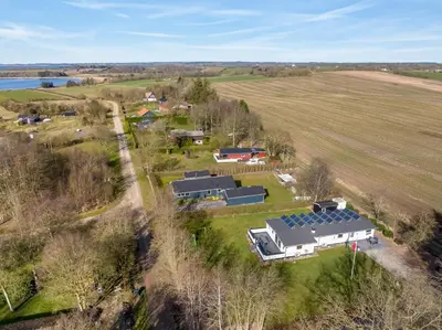 an aerial view of a farm with a house at Holiday Home With Pool And Spa Close To The Limfjord in Roslev