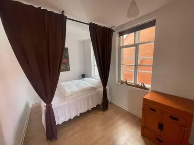 a bedroom with a bed and a window at Cozy base near the cathedral in Viborg