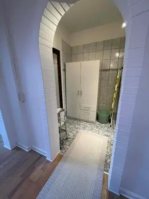 a room with an archway with a bathroom in it at Cozy base near the cathedral in Viborg
