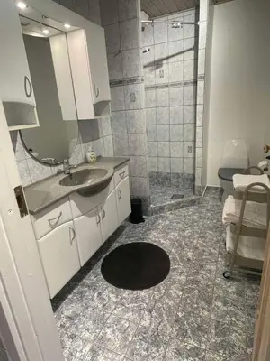 a bathroom with a sink and a shower at Cozy base near the cathedral in Viborg