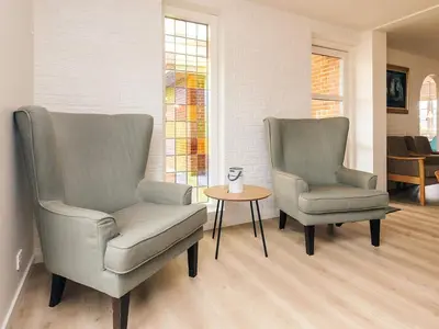 two chairs and a table in a living room at 4 star holiday home in Løgstør in Løgsted