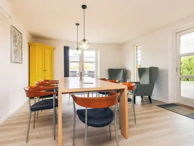 a dining room with a wooden table and chairs at 4 star holiday home in Løgstør in Løgsted