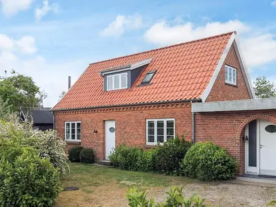 a red brick house with an orange roof at 4 star holiday home in Løgstør in Løgsted