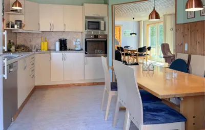 a kitchen and dining room with a table and chairs at Stunning Home In Farsø With Wifi in Farsø