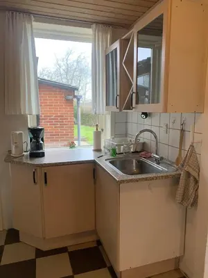 a small kitchen with a sink and a window at Townhouse centrally located close to Jesperhus in Nykøbing Mors