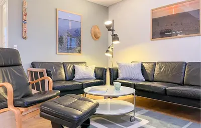 a living room with a couch and a table at Amazing Home In Vestervig With Sauna in Vestervig