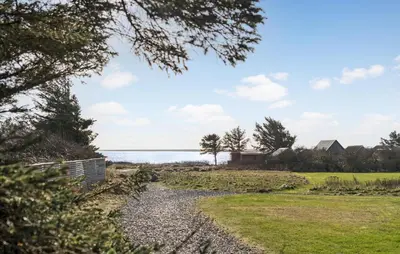 a gravel path leading to the water with trees at Amazing Home In Vestervig With Sauna in Vestervig